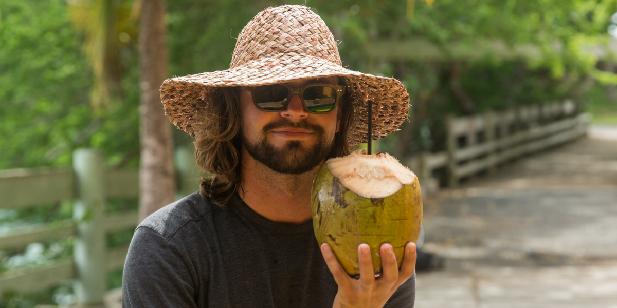 Adam Fricke posing with a coconut.