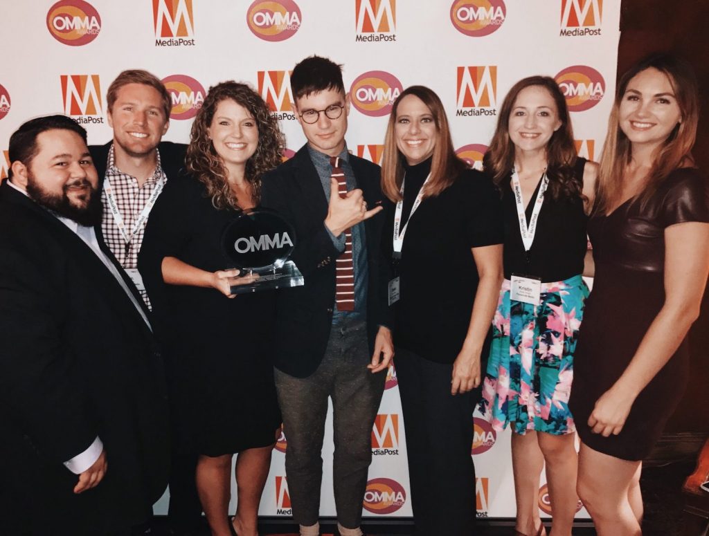 The Parachute Media team posing for a picture, holding their OMMA awards.