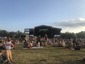 sitting in the grass looking at the Bonnaroo stage