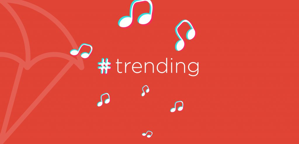 Red graphic with text that reads "#trending." Music symbols and a company logo is in the background.